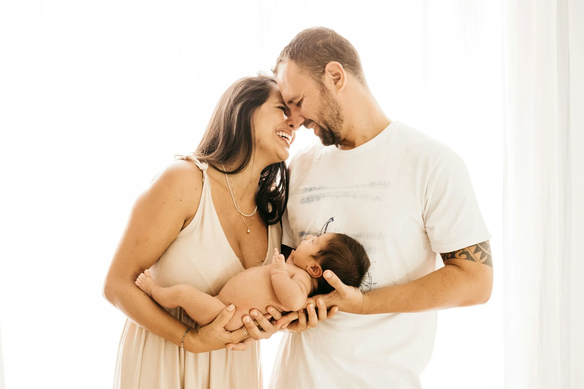 Parents holding their newborn baby close